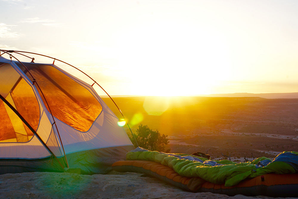 tent and sleeping bag at sunsrise