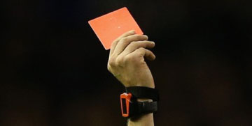 referee holding red card